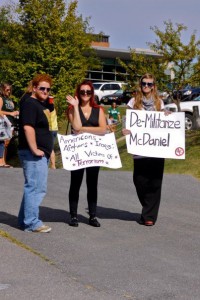 Sarina Arahovas and Julia Pitt display their signs at the football game on september 11. this photo, posted on the “students against self righteous Protesting” Facebook page, is listed in an album titled “ignorant shit.” Four people “liked” it.